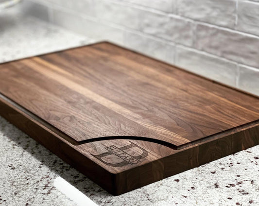 Large Walnut Cutting Board with juice groove around the edge and a monogram engraving on the bottom right